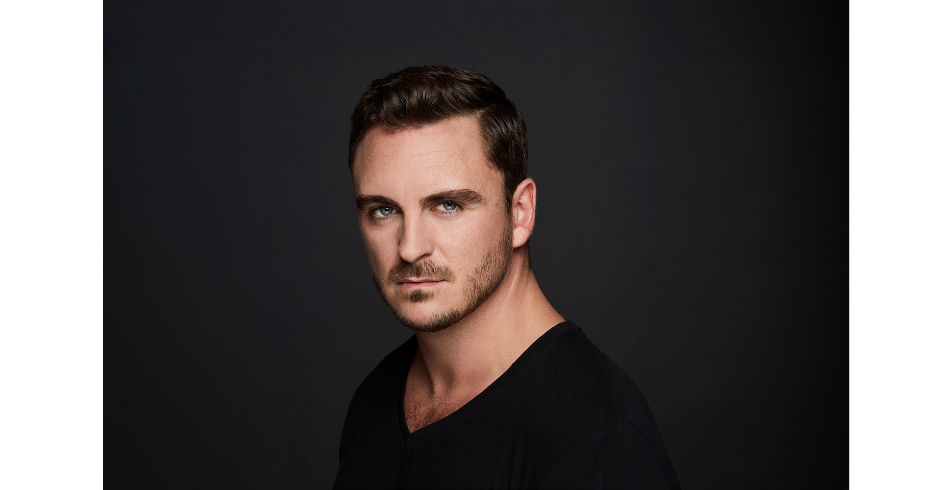Male actor on headshot front dark grey backdrop